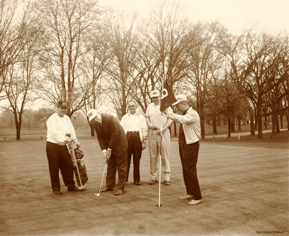 Group of men playing golf on a course